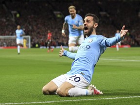 Manchester City's Bernardo Silva celebrates after scoring the opening goal during the English Premier League soccer match between Manchester United and Manchester City at Old Trafford Stadium in Manchester, England, Wednesday April 24, 2019.