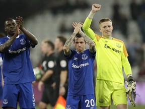Everton's Kurt Zouma, Bernard and goalkeeper Jordan Pickford, from left to right, celebrate at the end of the English Premier League soccer match between West Ham United and Everton at London Stadium in London, Saturday, March 30, 2019. Everton won 2-0 with goals by Zouma and Bernard.