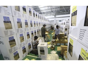 Workers prepare ballot boxes to be distributed to polling stations in Jakarta, Indonesia, Monday, April 15, 2019. The world's third-largest democracy is gearing up to hold its legislative and presidential elections on April 17.