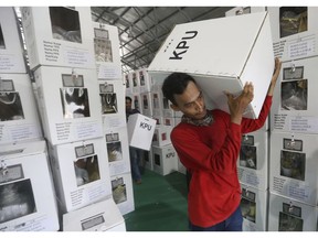 Workers carry ballot boxes to be distributed to polling stations in Jakarta, Indonesia, Tuesday, April 16, 2019. Nearly 193 million Indonesians are eligible to vote in presidential and legislative elections on Wednesday. President Joko Widodo, the first Indonesian president from outside the Jakarta elite, is competing against Prabowo Subianto, a former special forces general from the era of authoritarian rule under military dictator Suharto.