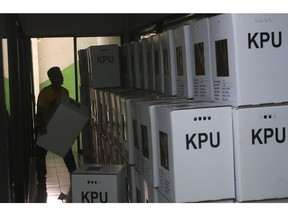A worker prepares ballot boxes to be distributed to polling stations in Jakarta, Indonesia, Monday, April 15, 2019. The world's third-largest democracy is gearing up to hold its legislative and presidential elections on April 17.