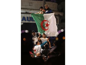 A crowd celebrates after ailing Algerian President Abdelaziz Bouteflika resigned after 20 years in power, Tuesday April 2, 2019 in Algiers. Bouteflika quit in a statement read on national television after the country's Defense Ministry aggressively called for Bouteflika to "immediately" vacate the office he held for two decades.
