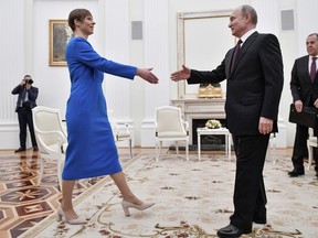 Russian President Vladimir Putin, right, greets Estonia's President Kersti Kaljulaid at the Kremlin in Moscow, Russia, Thursday, April 18, 2019.