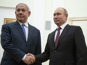 Russian President Vladimir Putin, right, shakes hands with Israeli Prime Minister Benjamin Netanyahu during their meeting in the Kremlin in Moscow, Russia, Thursday, April 4, 2019.