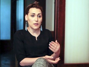 In this frame grab taken from the Associated Press Television footage on Friday, April 26, 2019, Lilit Martirosian, a founder of the Armenian transgender organization Right Side, gestures while her interview for the Associated Press in Yerevan, Armenia. A transgender woman whose address to the Armenian parliament caused an uproar says she has received death threats and is avoiding leaving her home because of security concerns.