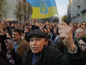Supporters of Ukrainian President Petro Poroshenko, who have come to thank him for what he did as a president, listen to his speech in Kiev, Ukraine, Monday, April 22, 2019. Political mandates don't get much more powerful than the one Ukrainian voters gave comedian Volodymyr Zelenskiy, who as president-elect faces daunting challenges along with an overwhelming directive to produce change.