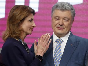 Ukrainian President Petro Poroshenko's wife Maryna stands with her husband at his headquarters after the second round of presidential elections in Kiev, Ukraine, Sunday, April 21, 2019. Ukrainian President Petro Poroshenko is accepting defeat in the election for the country's top post.