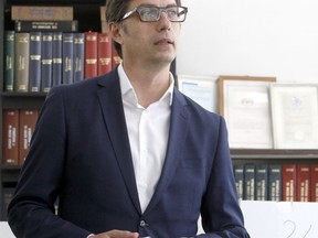 Stevo Pendarovski, a presidential candidate of the ruling coalition led by the Social Democrats, holds his ballot before voting for the presidential elections at a polling station in Skopje, North Macedonia, Sunday, April 21, 2019. North Macedonia holds the first round of presidential elections on Sunday, seen as key test of the government following deep polarization after the country changed its name to end a decades-old dispute with neighboring Greece over the use of the term "Macedonia".