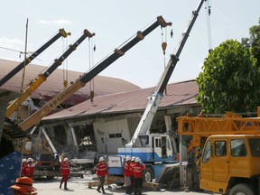 Workers fix the damage Tuesday, April 23, 2019 brought about by Monday's 6.1 magnitude earthquake that rocked Diosdado Macapagal International Airport at Clark Freeport, Pampanga province, north of Manila, Philippines. A strong earthquake struck the northern Philippines Monday trapping some people in a collapsed building, damaged an airport terminal and knocked out power in at least one province, officials said.