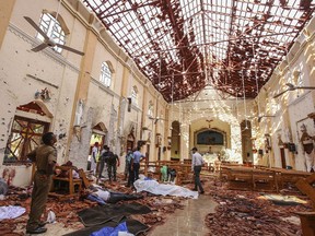 EDS NOTE: GRAPHIC CONTENT - FILE- In this April 21, 2019, file photo, dead bodies of victims lie inside St. Sebastian's Church in Negombo, north of Colombo, Sri Lanka. A picture of a determined local militant cell that suddenly went global is slowly emerging from the aftermath of grief and confusion of Sri Lanka's Easter bombings.