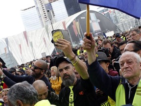 Jerome Rodriguez, center, a prominent figure of the yellow vests movement takes part in a rally in Paris, France, Saturday, April 6, 2019. Protesters from the yellow vest movement are taking to the streets of France for a 21st straight weekend, with hundreds gathered for a march across Paris, one of numerous protests around the country.
