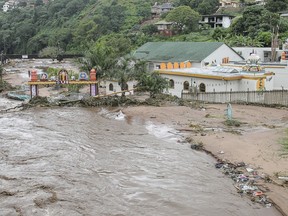 Floodwaters wash through a property near Durban, South Africa, Tuesday, April 23, 2019. South African media report Tuesday that at least 33 people are dead from flooding and mudslides in the country's eastern KwaZulu-Natal province caused by heavy rains that began on Monday. (AP Photo)