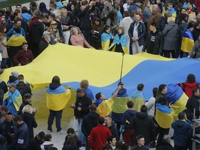 People hold Ukrainian national flag at the Olympic stadium prior debates between two candidates in the weekend presidential run-off in Kiev.
