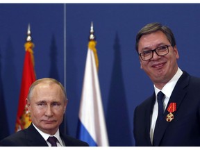 FILE - In this photo taken Thursday, Jan. 17, 2019, Russian President Vladimir Putin, left, poses with Serbian President Aleksandar Vucic after being awarded the Order of Alexander Nevsky in Belgrade, Serbia. Serbia is seeking an increased Russian role in the European Union-mediated talks with the former province of Kosovo, the move which could further strain the Balkan country's relations with the West. Serbia's Foreign Minister Ivica Dacic said after meeting his Russian counterpart Sergey Lavrov on Wednesday, April 17 in Moscow that "Serbia cannot defend its state interests without the assistance of the Russian Federation."