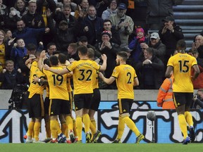 Wolverhampton's Ruben Neves celebrates with teammates after scoring his side's opening goal during the English Premier League soccer match between Wolverhampton Wanderers and Arsenal at the Molineux Stadium in Wolverhampton, England, Wednesday, April 24, 2019.