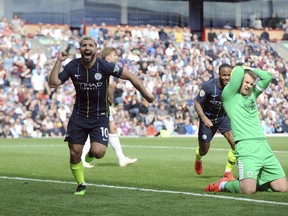 Manchester City's Sergio Aguero, left, celebrates after scoring his side's opening goal during the English Premier League soccer match between Burnley and Manchester City at Turf Moor in Burnley, England, Sunday, April 28, 2019.
