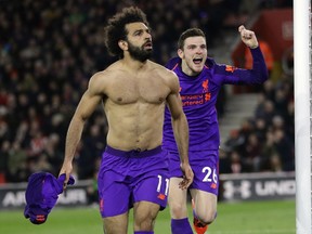 Liverpool's Mohamed Salah, left, celebrates after scoring his side's second goal during the English Premier League soccer match between Southampton and Liverpool at St Mary's stadium in Southampton, England Friday, April 5, 2019.