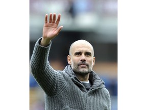 Manchester City manager Josep Guardiola waves to supporters at the end of the English Premier League soccer match between Burnley and Manchester City at Turf Moor in Burnley, England, Sunday, April 28, 2019.