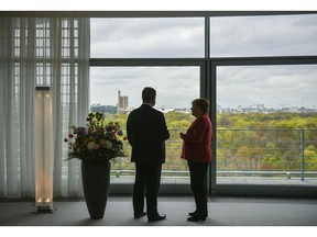 German Chancellor Angela Merkel, right, and the President of Ukraine Petro Poroshenko are talking during a meeting in Berlin, Germany, Friday, April 12, 2019.