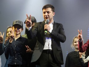 FILE - In this Friday, March 29, 2019 file photo, Volodymyr Zelenskiy, Ukrainian actor and candidate in the upcoming presidential election, hosts a comedy show at a concert hall in Brovary, Ukraine. Ukraine's presidential runoff on Sunday, April 21, is a battle between a billionaire tycoon who rode anti-Russian protests to the nation's top office five years ago, and a comedian who plays a president in a TV sitcom. The actor has used humor and social media to take pole position.