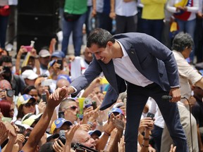Venezuela's opposition leader and self proclaimed president Juan Guaido, greets the crowd during a rally in Caracas, Venezuela, Saturday, April 27, 2019. The Trump administration has added Venezuelan Foreign Minister Jorge Arreaza to a Treasury Department sanctions target list as it increases pressure on Guaido's opponent, embattled President Nicolas Maduro.