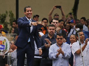 Juan Guaido, opposition leader and self-proclaimed interim president of Venezuela, points to supporters as he arrives to Plaza Bolivar for an outdoor, town hall-style meeting in the Chacao area of Caracas, Venezuela, Friday, April 19, 2019. The opposition held the forum to announce a new strategy against the government of President Nicolas Maduro.