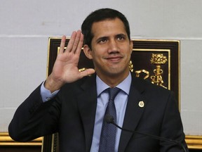 Juan Guaido, President of National Assembly and self-proclaimed interim president waves to the gallery during a session of the National Assembly in Caracas, Venezuela, Tuesday, April 2, 2019. Venezuela's chief justice on Monday asked lawmakers of the rival pro-government National Constituent Assembly to strip Guaido of his parliamentary immunity, taking a step toward prosecuting him for alleged crimes as he seeks to oust President Nicolas Maduro.
