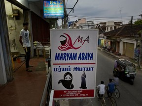 A billboard displays garments worn by Muslim women, at a women's clothing shop in Kattankudy, Sri Lanka, Monday, April 29, 2019. After being targeted by Islamic State suicide bombings on Easter, Sri Lanka has banned the niqab face veil, which increasingly has been seen in Muslim areas of the island nation's east.