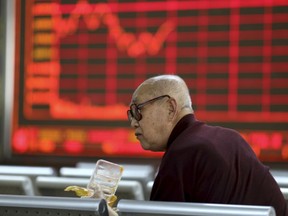 An investor finishes his meal at a stock brokerage in Beijing on Tuesday, April 23, 2019. Asian stocks were mixed on Tuesday while oil prices soared to their highest level since October after the U.S. said it would soon impose sanctions on all buyers of Iranian oil.