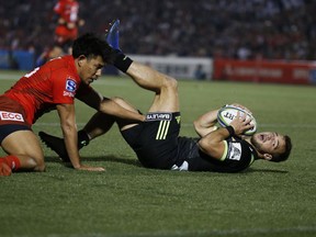 Hurricane's Wes Goosen, right, scores a goal during the Super Rugby game between the Hurricanes and Sunwolves in Tokyo, Friday, April 19, 2019.
