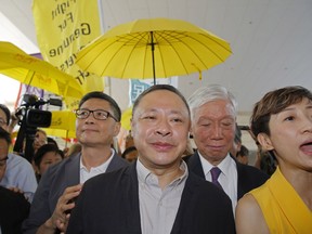 Occupy Central leaders, from left, Chan Kin-man, wearing glasses, Benny Tai, Chu Yiu-ming and Tanya Chan enter a court in Hong Kong, Wednesday, April 24, 2019. The court is preparing to sentence nine leaders of massive 2014 pro-democracy protests convicted last month of public nuisance offenses. The sentences to be handed down Wednesday are seen as an effort by the government of the semi-autonomous Chinese territory to draw a line under the protests.