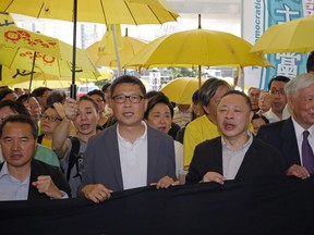 Occupy Central leaders, from left, Lee Wing-tat, Chan Kin-man, Benny Tai and Chu Yiu-ming enter a court in Hong Kong, Wednesday, April 24, 2019. The court is preparing to sentence nine leaders of massive 2014 pro-democracy protests convicted last month of public nuisance offenses. The sentences to be handed down Wednesday are seen as an effort by the government of the semi-autonomous Chinese territory to draw a line under the protests.