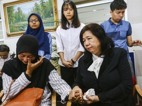 In this photo taken Wednesday, April 3, 2019, Norhayati Mohd Arifin, sitting at left, wife of Amri Che Mat and Susanna Liew Sow Yoke,  sitting at right, wife of Pastor Raymond Koh react during the announce the findings of the Public Inquiry into the disappearances of Pastor Raymond Koh and Amri Che Mat at National Human Rights Commission office in Kuala Lumpur, Malaysia. Malaysia's government was urged Thursday to reinvestigate the disappearances of a Christian pastor and a Muslim activist after a public inquiry concluded the duo were abducted by the police special branch over matters against Islam.