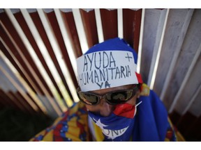 FILE - In this Feb. 23, 2019 file photo, an opposition supporter wears a message on his forehead that reads in Spanish: "Humanitarian aid now," during a demonstration urging soldiers to allow the entry of U.S. humanitarian aid, in Caracas, Venezuela. Human Rights Watch and public health researchers from Johns Hopkins are urging the United Nations, who are meeting Wednesday, April 10, 2019, to declare the situation in Venezuela "a complex humanitarian emergency that poses a serious risk to the region."