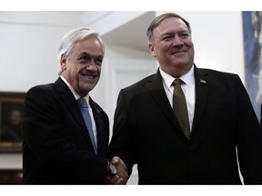 Chile's President Sebastian Piñera and U.S. Secretary of State Mike Pompeo, pose for photos at La Moneda Palace, in Santiago, Chile, Friday, April 12, 2019. Pompeo met Friday with Piñera to address, mainly, the vast crisis that afflicts Venezuela in the first round of a tour that includes Paraguay, Peru and Colombia.