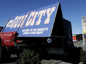 A billboard advertises a gun shop in Christchurch, New Zealand, Monday, April 1, 2019. New Zealand's government has introduced a bill to ban the types of weapons used by a terrorist to kill 50 people at two mosques.