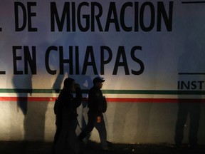 Federal police enter an immigration detention center in Tapachula, Chiapas state, Mexico, late Thursday, April 25, 2019. A large group of mainly Cuban migrants escaped on foot from the immigration detention center on Mexico's southern border in the largest mass escape in recent memory. Later, about half of the group returned voluntarily.