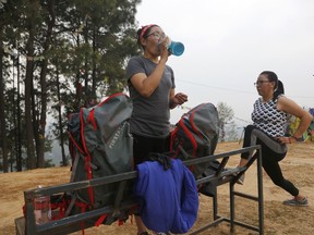 In this photo taken Saturday, March 30, 2019, Nima Doma, 34, left, and Furdiki Sherpa, 43, perform morning exercises as they train to summit Mount Everest, in Kathmandu, Nepal. Five years after one of the deadliest disasters on Mount Everest, three people from Nepal's ethnic Sherpa community, including Doma and Sherpa, are preparing an ascent to raise awareness about the Nepalese mountain guides who make it possible for hundreds of foreign climbers to scale the mountain and survive. The two women lost their husbands in the 2014 ice avalanche on Everest's western shoulder that killed 16 fellow Sherpa guides.
