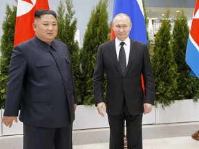 Russian President Vladimir Putin, right, and North Korea's leader Kim Jong Un pose for a picture during their meeting in Vladivostok, Russia, Thursday, April 25, 2019. Putin and Kim are set to have one-on-one meeting at the Far Eastern State University on the Russky Island across a bridge from Vladivostok. The meeting will be followed by broader talks involving officials from both sides.