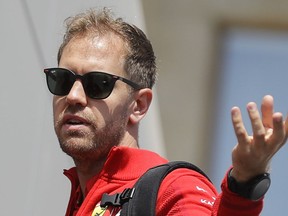 Ferrari driver Sebastian Vettel of Germany gestures before the first free practice at the Baku Formula One city circuit, in Baku, Azerbaijan, Friday, April 26, 2019. The Formula One race will be held on Sunday.