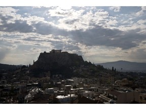 The 5th Century B.C. Parthenon temple stands the ancient Acropolis hill after a rainstorm in Athens, on Wednesday, April 17, 2019. Greek officials say four people have been lightly injured after lightning struck the Acropolis in Athens during a rainstorm. A culture ministry official told The Associated Press there was no initial indication of damage to the monuments on the ancient citadel, which include the 5th Century B.C. Parthenon temple.