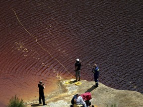 Investigators search for bodies with a special camera in a man-made lake near the village of Mitsero outside of the capital Nicosia, Cyprus, Saturday, April 27, 2019.
