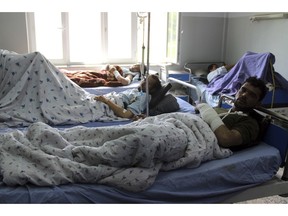 Injured men receive treatment at a hospital, after a clash between Taliban and security forces in Kunduz province north of Afghanistan, Saturday, April 13, 2019. An Afghan official says the Taliban fighters have launch attacks on Afghan security forces in northern Kunduz city, killing six people and so far more than 50 others were wounded.