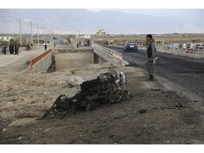 An Afghan security force stand guard at the site a day after an a suicide attack near the Bagram Air Base, north of Kabul, Afghanistan, Tuesday, April 9, 2019. Three American service members and a U.S. contractor were killed when their convoy hit a roadside bomb on Monday near the main U.S. base in Afghanistan, the U.S. forces said. The Taliban claimed responsibility for the attack.