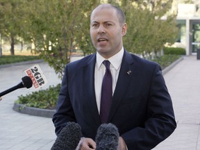 Australian Treasurer Josh Frydenberg addresses the media as he arrives at Parliament House in Canberra, Australia,  Tuesday, April 2, 2019. Frydenberg said he will unveil Australia's first balanced annual budget plan in a decade days before general elections are called.