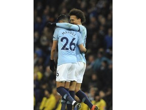 Manchester City's Leroy Sane, right, celebrates with teammate Riyad Mahrez after scoring his side's second goal during the English Premier League soccer match between Manchester City and Cardiff City at Etihad stadium in Manchester, England, Wednesday, April 3, 2019.