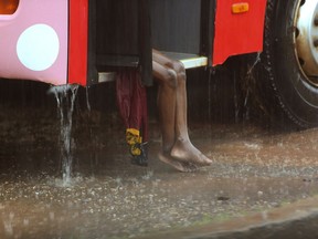 A child sits on a bus during rainfall, in Natite neighbourhood, in Pemba, on the northeastern coast of Mozambique, Sunday, April, 28, 2019. Serious flooding began on Sunday in parts of northern Mozambique that were hit by Cyclone Kenneth three days ago, with waters waist-high in areas, after the government urged many people to immediately seek higher ground. Hundreds of thousands of people were at risk.