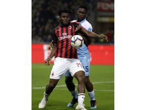 AC Milan's Franck Kessie, left, and Lazio's Quissanga Bastos challenge for the ball during the Italian Cup, second leg semifinal soccer match between AC Milan and Lazio, at the San Siro stadium, in Milan, Italy, Wednesday, April 24, 2019.