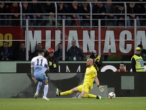 Lazio's Joaquin Correa, left, scores the opening goal of his team during the Italian Cup, second leg semifinal soccer match between AC Milan and Lazio, at the San Siro stadium, in Milan, Italy, Wednesday, April 24, 2019.