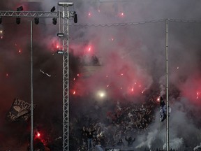 PAOK fans cheer on their team during a Greek Super League soccer match against Levadiakos in Thessaloniki, northern Greece, on Sunday, Apr. 21, 2019.